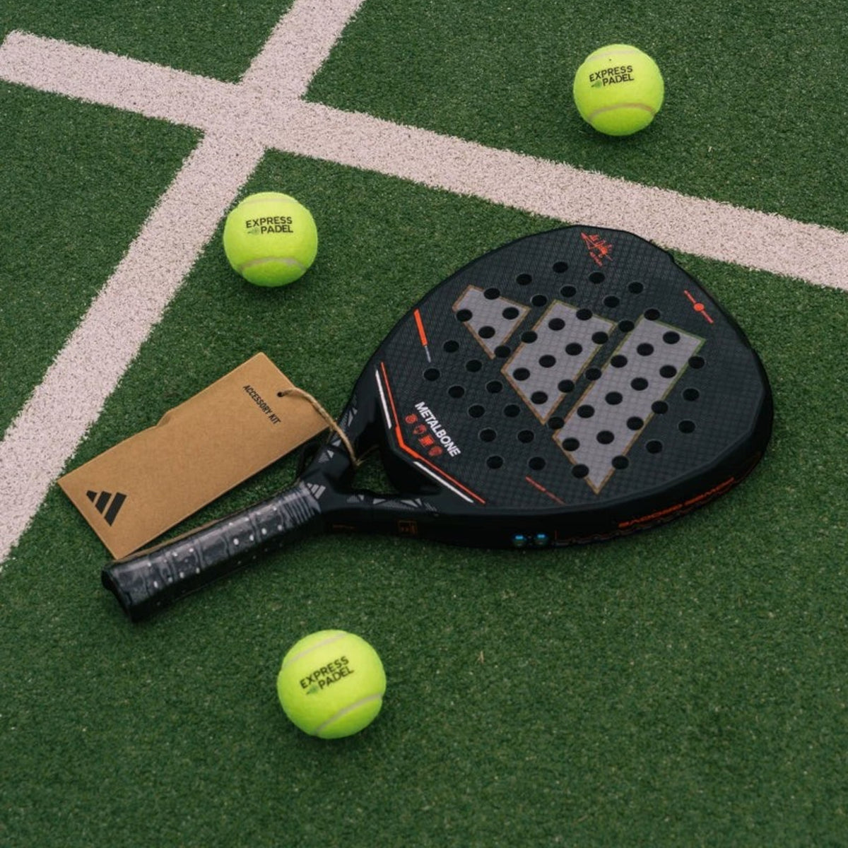 Axeblu Ltd Adidas Metalbone 2026 Ale Galan padel racket with carbon finish and accessory kit on a green court